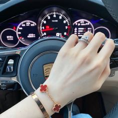 Cartier Love bangle with red clover bracelet