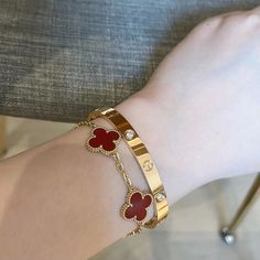 Cartier Love bangle with red clover bracelet