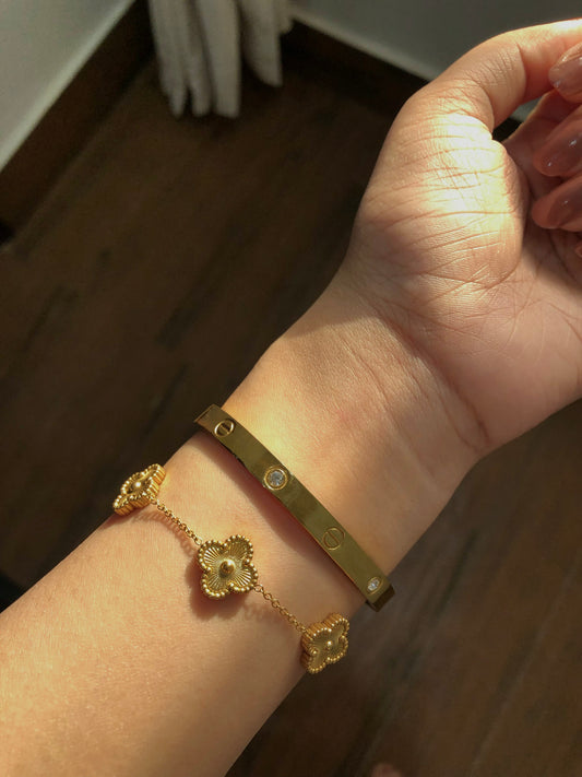 Cartier love bangle with golden clover bracelet